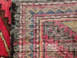 a close up of a rug with a red and blue design on it