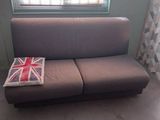a couch with a union jack on it in front of a window