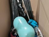 a cardboard box filled with assorted sports equipment