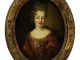 portrait d'une dame en robe marron, dans un cadre ovale doré