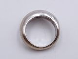 a close up of a silver ring on a white surface