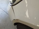 a close up of a car ' s headlight on the side of the road