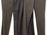 trois pantalons pour homme suspendus à un portant, sur fond blanc