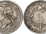 a silver coin with an image of a woman on it