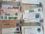 a lot of old letters and envelopes on the table
