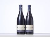 two bottles of wine sitting on top of a table