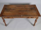 an old wooden table with two drawers and a drawer underneath it