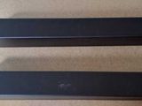 deux enceintes noires posées sur une table en bois