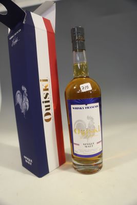 a bottle of alcohol sitting next to a box of wine