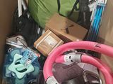 a cardboard box filled with assorted items and a pink hose