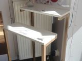 a small desk with a computer on top of it