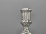 an antique silver plated candle holder sitting on a table