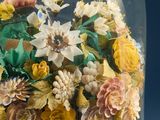 a glass cloche with a bunch of flowers inside of it
