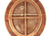 a wooden circular object with a cross on it