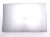 dell laptop computer sitting on top of a white table next to a keyboard