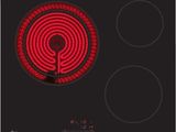 a close up of a stove top with a red light on it