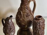 three vases sitting on a glass table next to each other