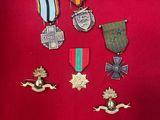 a close up of a bunch of medals on a red surface
