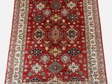 a red rug with a diamond design on it