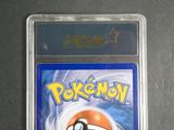 the pokemon card is in a clear plastic holder on a table