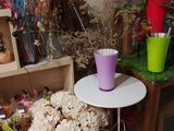 a small table with a vase of flowers on top of it
