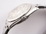 a close up of a watch on a white surface