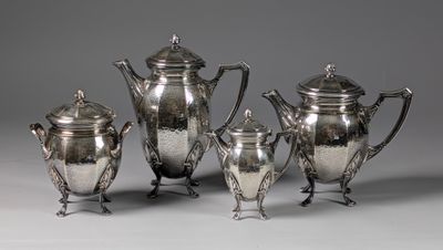 a group of five silverplated tea and coffee pots