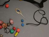 a pair of scissors and a pair of beads on a table