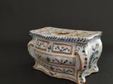 a white vase with a blue and orange design on it