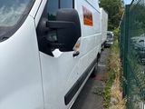 a white van that is parked next to a fence