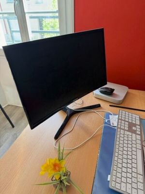 a desk with a keyboard, mouse, and monitor on it