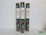 three rolls of wrapping paper sitting on top of a table