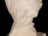 marble bust of a woman on a marble base with a black background