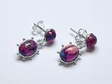 une paire de boucles d'oreilles en pierre rose et violette posées sur un fond blanc