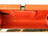 an image of an orange purse with a gold handle