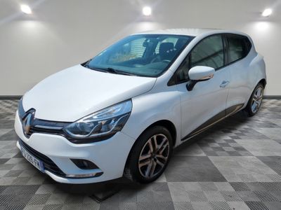 the white car is parked on a checkered tile floor