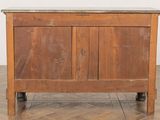a wooden cabinet with a marble top on a wooden floor