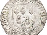 a silver coin with a coat of arms on it