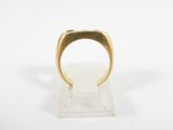 an image of a gold ring on a clear stand