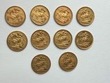 six different types of gold coins on a white surface