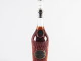 an empty bottle of brandy sitting on a white surface