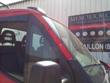 a red van that is parked in front of a building