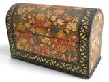 an old wooden box with a floral design on it