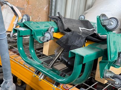 a green machine that is sitting on top of a pallet
