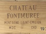 une caisse en bois sur laquelle est accrochée une pancarte indiquant « Château Fonture »