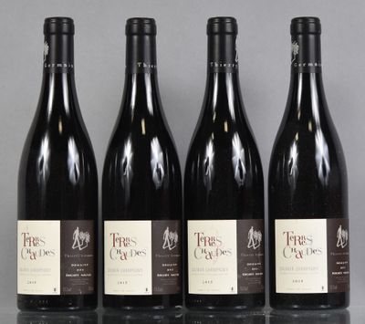four bottles of wine are lined up on a table