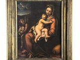 un vieux tableau représentant une femme tenant un bébé sur ses genoux