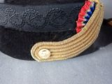 a black hat with a red and blue ribbon on it