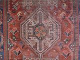 a red and blue rug with a design on it