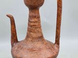 an image of a brown vase with a handle on a table